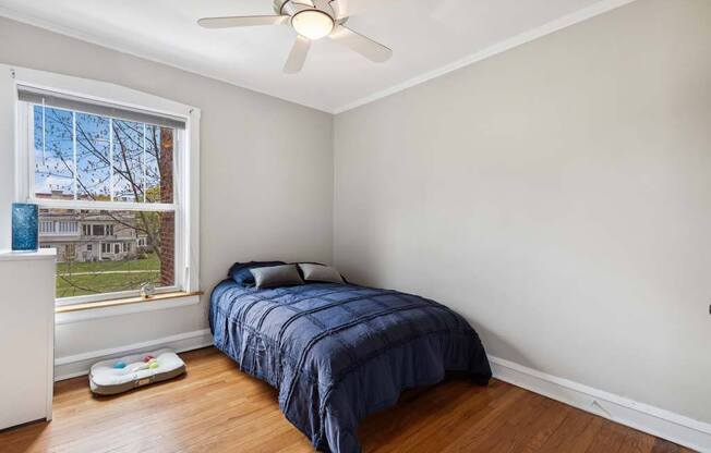 a bedroom with a bed and a ceiling fan at The Bryant at Oak Park I & II, Oak Park, IL