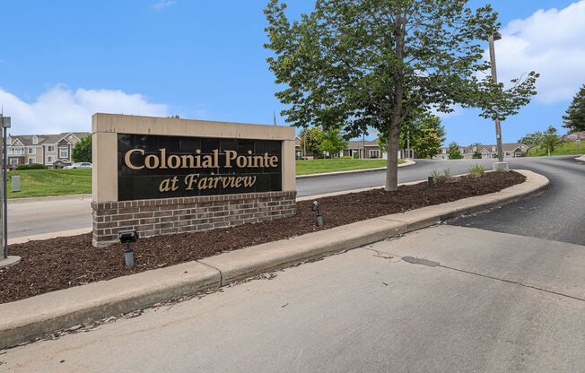 entrance sign for Colonial Pointe at Fairview Apartments in Bellevue, NE