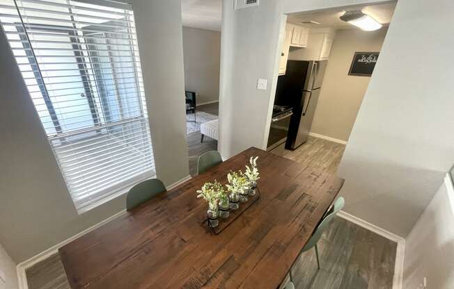 a dining room with a wooden table and green chairs  at 2151 Kirkwood, Houston, Texas