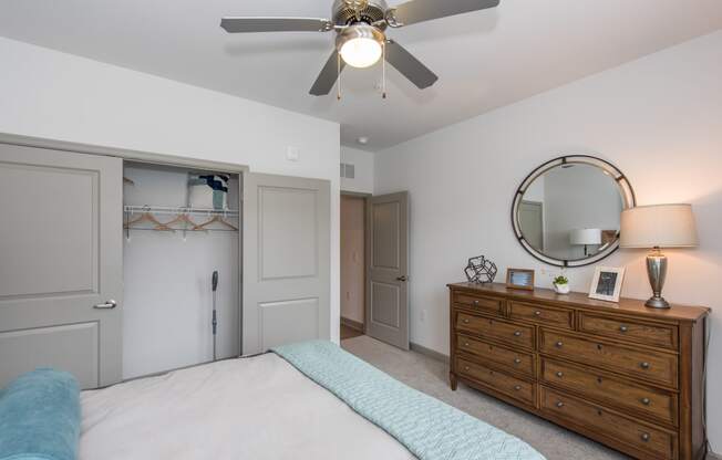 a bedroom with a bed and a dresser with a mirror at The Whitworth, Williamsburg, Virginia