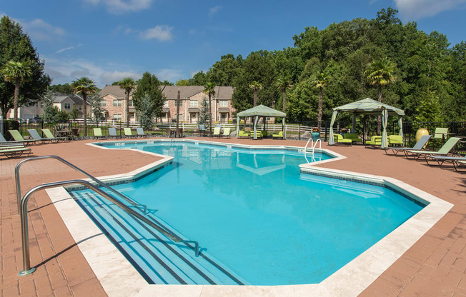 our apartments have a resort style pool with chairs and umbrellas