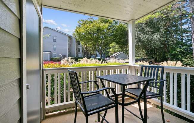 a patio with a table and chairs on a balcony