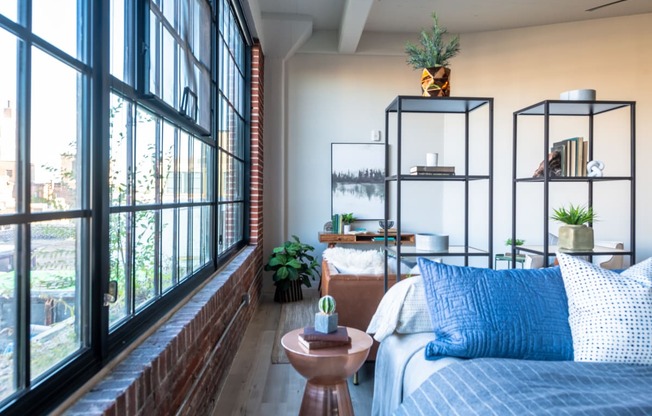 a bedroom with a bed and a large window at The 22 Apartments, St. Louis, MO