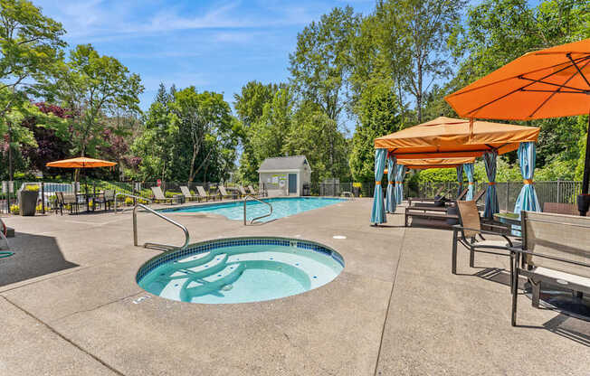 A pool with a hot tub and a sunshade.