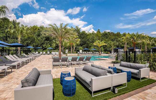 A poolside area with lounge chairs and umbrellas.