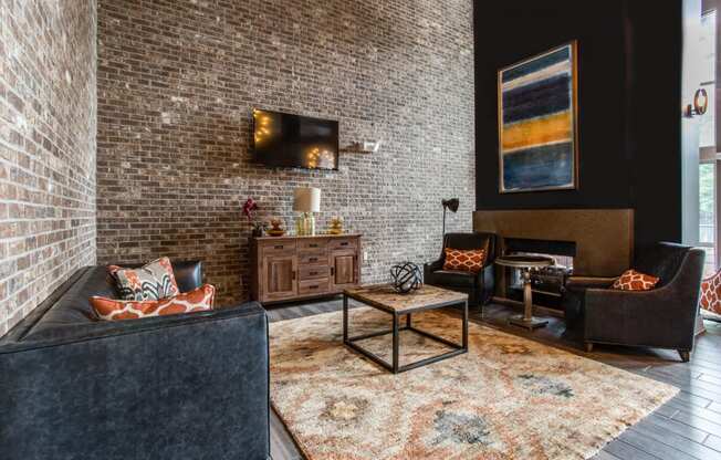a living room with a brick wall and a couch and a table
