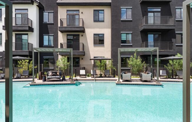 Resort-style pool and spa with spacious sundeck seating and private cabanas create an elevated outdoor retreat.