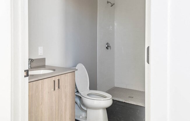 an empty bathroom with a toilet and a shower