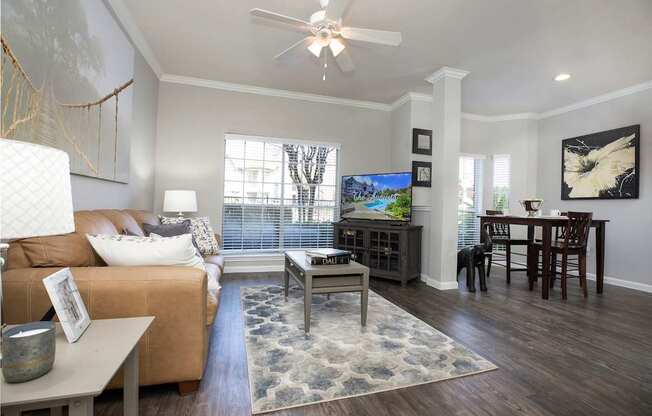 an open living room and dining room with a ceiling fan