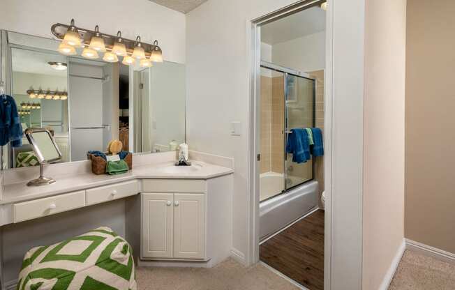 a bathroom with a large mirror and a sink and a shower