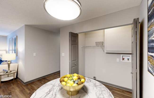 a living room with a table with a bowl of fruit on it