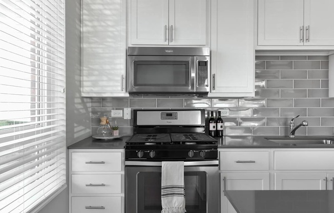 A modern kitchen with white cabinets and a black and white color scheme.