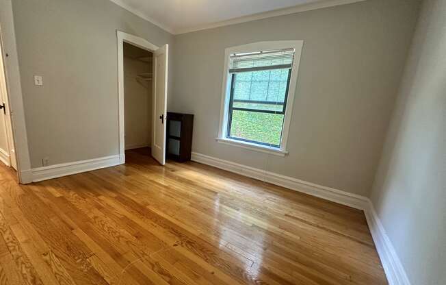 a living room with wood floors and a window