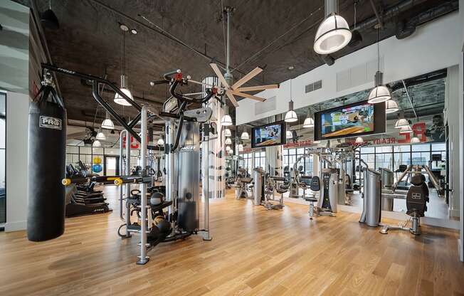 a large fitness room with cardio equipment and flat screen tvs at Altis Grand Central, Tampa Florida