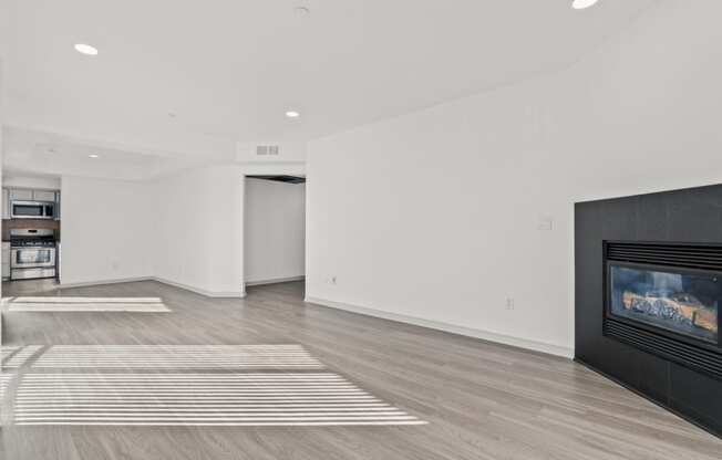 a living room with a fireplace and white walls