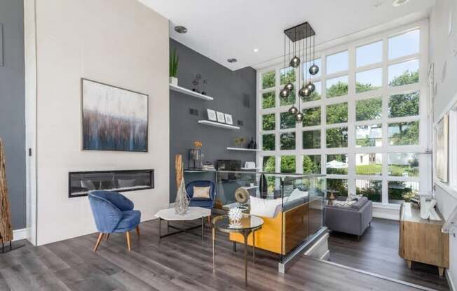 A living room with a fireplace and a painting on the wall.