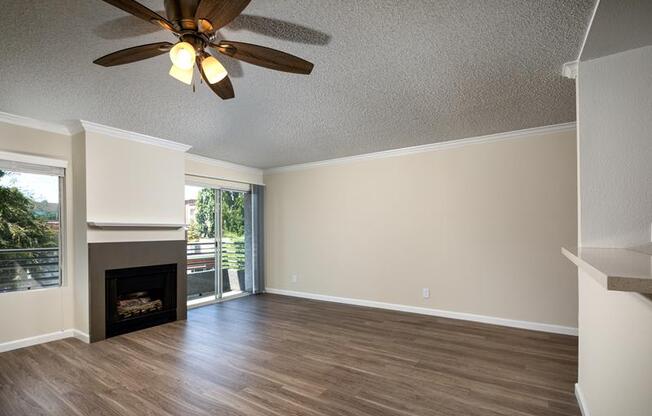 living room with a ceiling fan and a fireplace