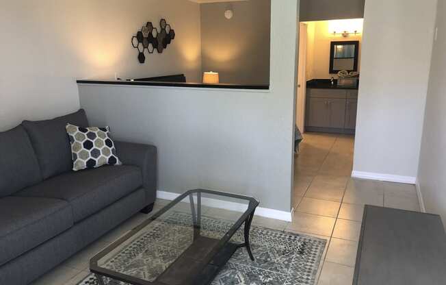 a living room with a couch and a coffee table at Colonial Apartments, Florida, 32808