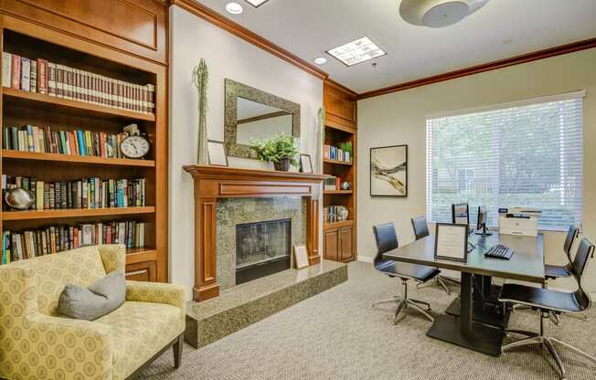 a room with a fireplace and a table and chairs