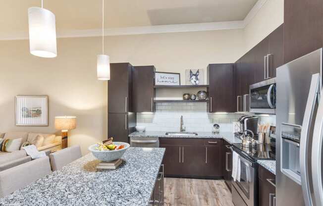 Westwood Green Apartments Kitchen with large island, stainless appliances, and quartz countertops