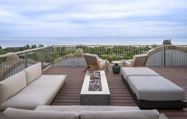 a terrace with couches and chairs overlooking the ocean at the Belden Stratford in Chicago, 60614