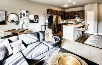 Modern living room with natural lighting at Sterling at Prairie Trail in Ankeny, IA