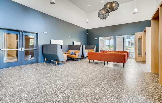 a lobby with couches and chairs and a coffee table