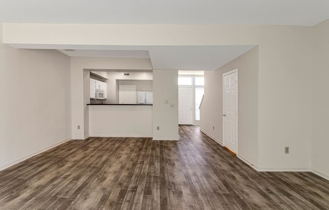 This is a photo of the living room and dining area of the 1280 square foot 2 bedroom, 2 and 1/2 bath Oakwood floor plan at Washington Park Apartments in Centerville, OH.