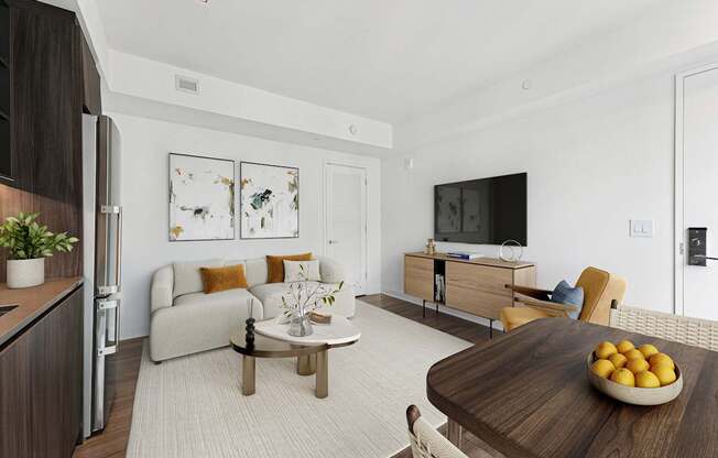 A modern living room with a wooden table and a bowl of lemons on it.