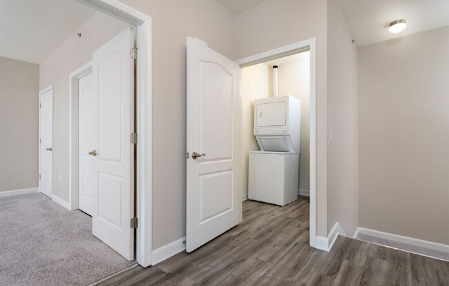 a bedroom with a washer and dryer