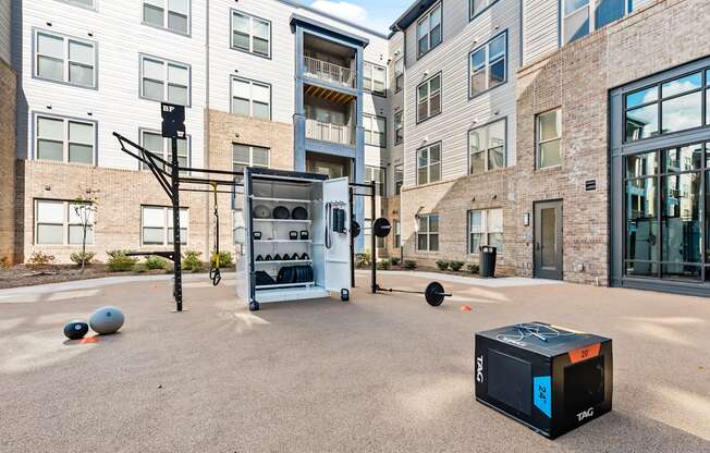 Outdoor fitness center with free weights at Preston Ridge Apartments in Cary, NC.
