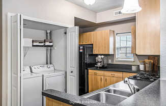 An end style kitchen with a washer and dryer at Lynbrook Apartments and Townhomes, Elkhorn, NE, 68022