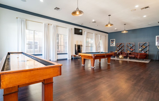 a game room with a pool table and ping pong