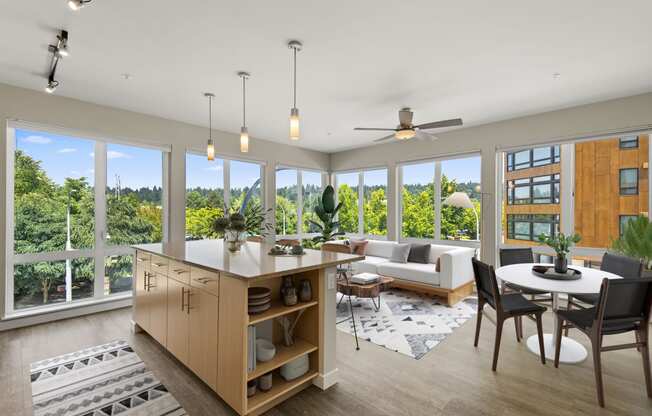 a living and dining area with a kitchen and a large window