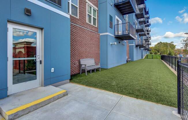 our apartments have an outdoor patio with a lawn and a brick building