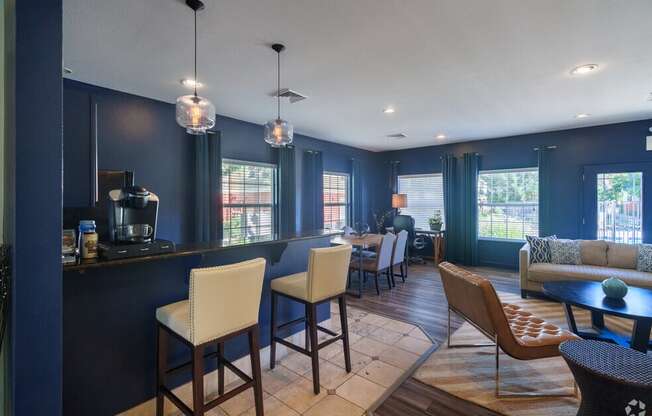 a living room and dining room with blue walls and a table and chairs