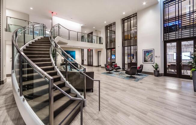 Spacious lobby with sweeping staircase and inviting seating areas.