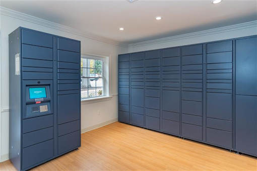 A room with a large number of dark blue lockers.