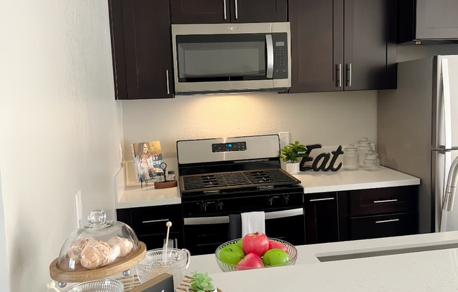 a kitchen with black cabinets and a counter top