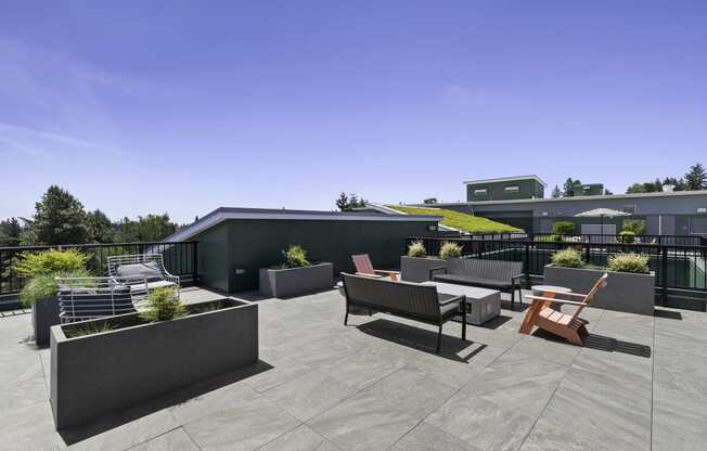 a rooftop patio with a green roof and a variety of seating and tables at Sedona Apartments, Seattle