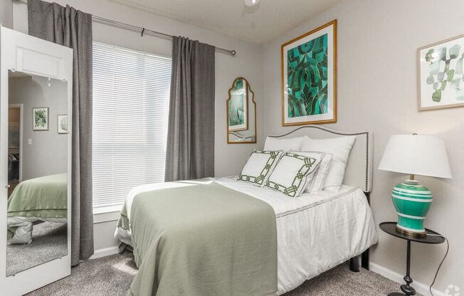 a bedroom with a bed and a mirror