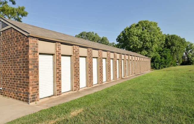 a long brick building with white garage doors