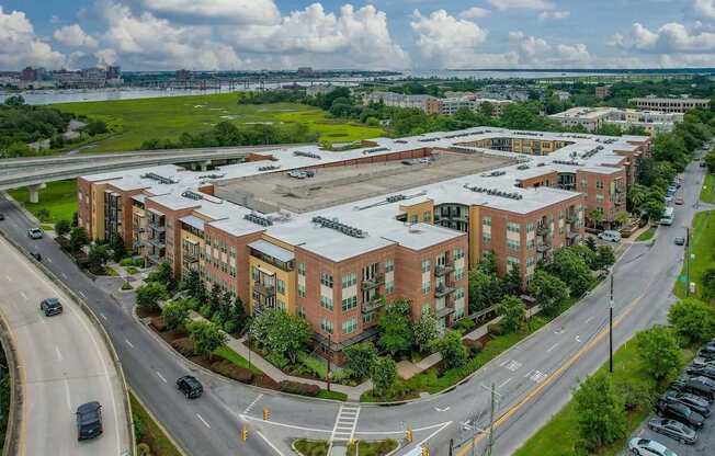 A large building complex with a parking lot in front.