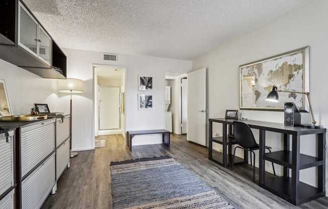 A room with a desk and a chair in it.