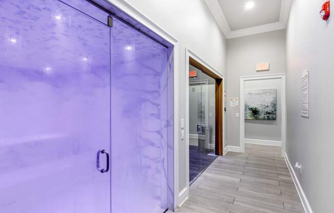 a large glass door leading to a hallway with a tile floor at Crossgates Apartment Homes, Starkville, Mississippi