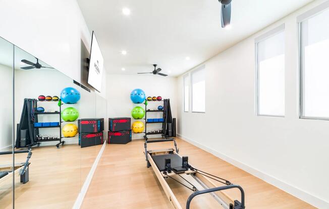 Stay active with Modera Trailhead’s fitness studio, featuring a variety of equipment including a Pilates reformer for balanced workouts.