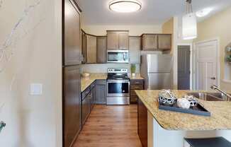 a kitchen with wooden cabinets and stainless steel appliances