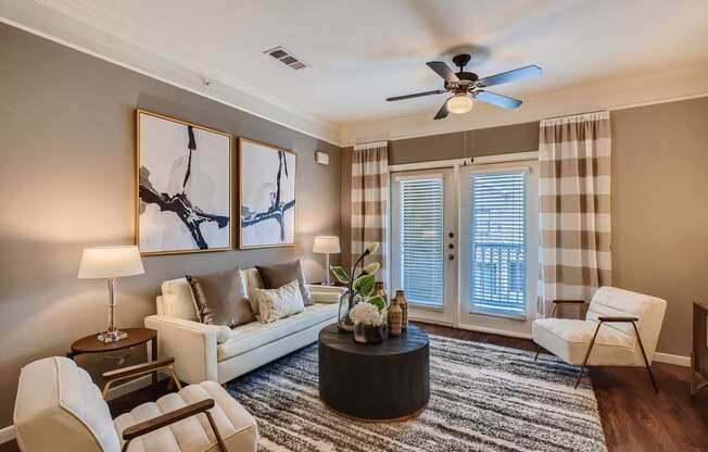 a living room with a couch and a ceiling fan