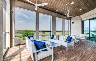 A modern living room with a wooden floor and a ceiling fan.