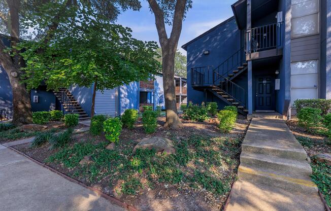 a path with trees on the side of a building